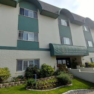 A welcoming hotel entrance surrounded by well-maintained landscaping.