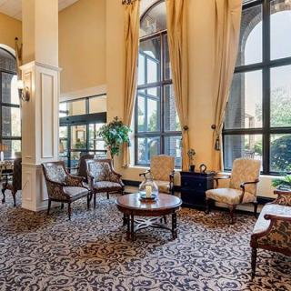 An elegant hotel lobby with comfortable seating and large windows.