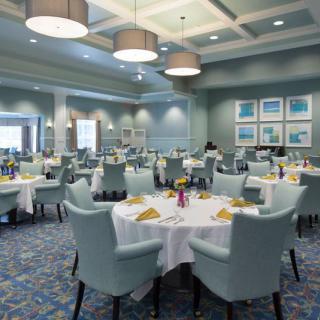 An elegantly designed restaurant dining area with neatly arranged tables and chairs.