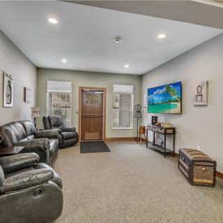 A modern living room with comfortable seating, a large television, and tasteful decor.