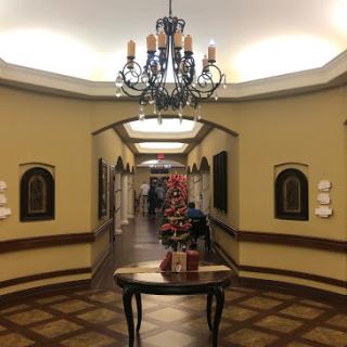 A beautifully decorated hallway featuring a chandelier and elegant furnishings.