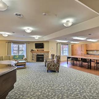 A spacious living room with comfortable seating, a fireplace, and a television.