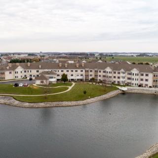 An aerial view of a residential complex situated by a lake.