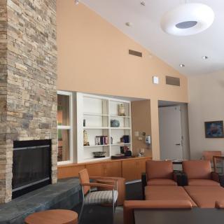 A modern living room with a fireplace and comfortable seating arrangements.