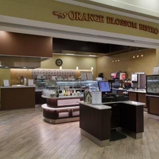 A cozy cafe with a well-organized counter and dessert display.
