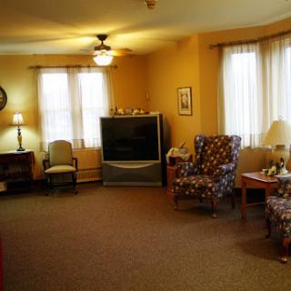 A cozy and well-lit living room featuring comfortable seating arrangements.