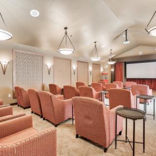 A cozy theater room with comfortable seating and a large screen.