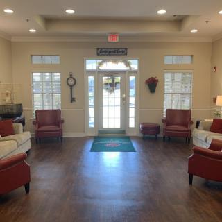 A well-lit and cozy lobby area with comfortable seating and decor.