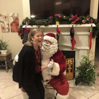 A joyful moment with Santa Claus during a festive holiday gathering.