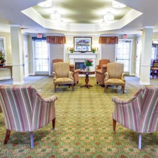 A cozy seating area with armchairs arranged around a fireplace.