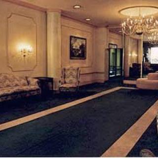Elegant hotel lobby with classic decor and a grand chandelier.