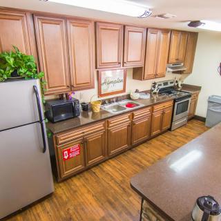 A modern kitchen with wooden cabinets and stainless steel appliances.