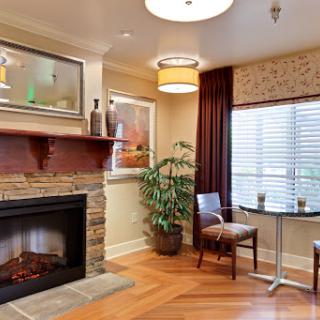 A cozy living room featuring a warm fireplace, comfortable seating, and stylish decor.
