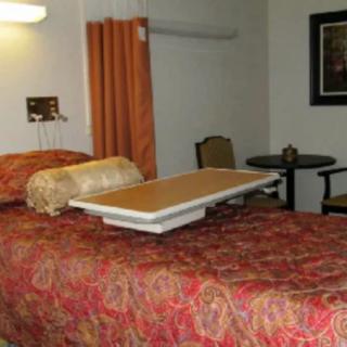 A hospital room with a bed and medical equipment.