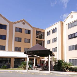 A modern hotel building with multiple stories and a covered entrance.