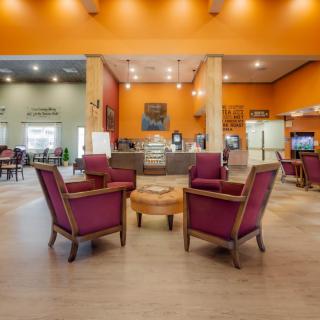 A modern lobby with comfortable seating and warm decor.
