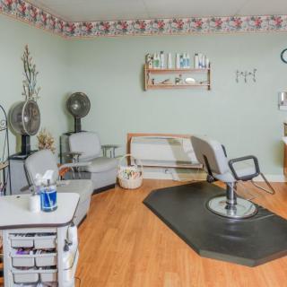 A quaint hair salon interior with styling chairs and beauty equipment.