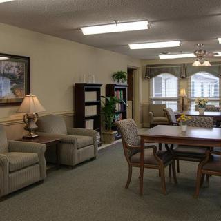 A cozy living room area featuring comfortable seating and a wooden dining table.
