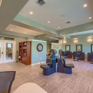 A modern salon interior with stylish chairs and mirrors.