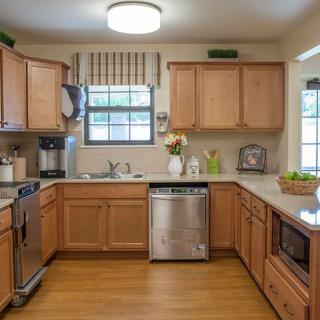 A modern kitchen with wooden cabinets and stainless steel appliances.