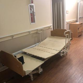 An empty hospital bed in a patient room.
