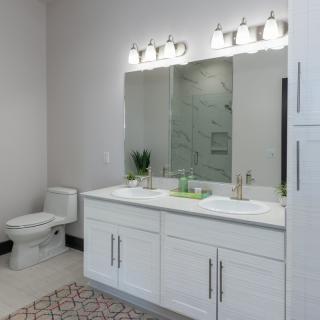 Modern bathroom with a double vanity and bright lighting.