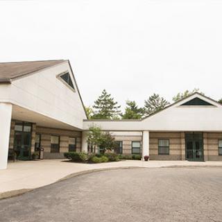 A modern architectural building with landscaped surroundings.