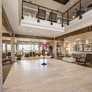 A modern and spacious lobby area featuring elegant furniture and lighting.