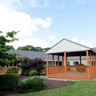 A scenic outdoor setting with a wooden gazebo and surrounding greenery.