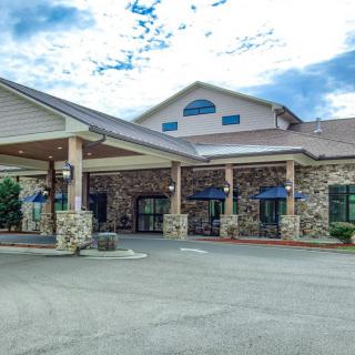 A hotel entrance with a stone facade and peaked roof.