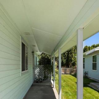 Covered porch with lattice and view of the garden