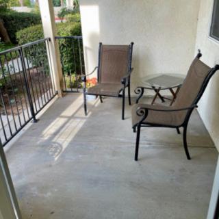 A cozy patio with two chairs and a small table.