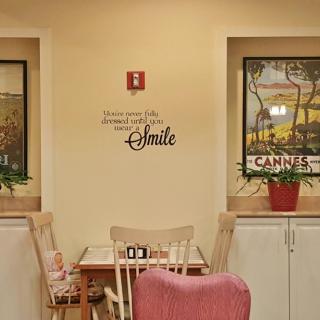 A cozy dining area with inspirational wall art and decorative posters.