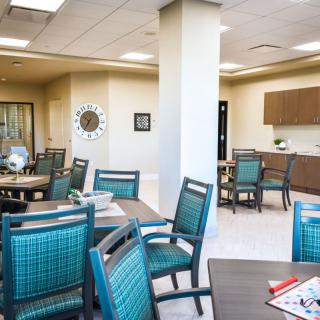 A modern room with a seating area and kitchenette.