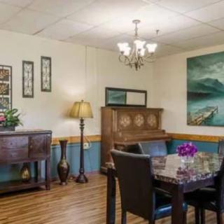 A cozy dining room with elegant furnishings and artwork on the walls.