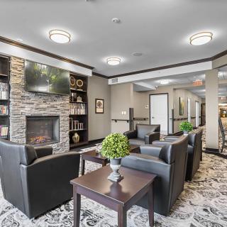 A modern lobby with a cozy seating area featuring a fireplace and stylish decor.