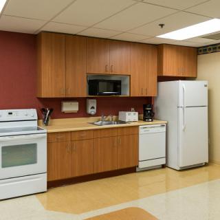 A modern kitchen with appliances including a stove, microwave, refrigerator, and dishwasher.