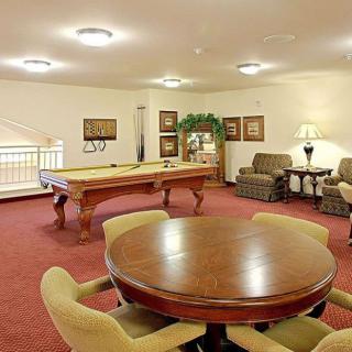 A cozy game room featuring a pool table and comfortable seating area.