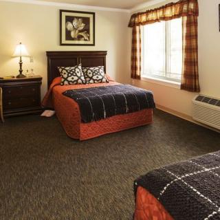 A cozy hotel room with two neatly made beds and a warm ambiance.