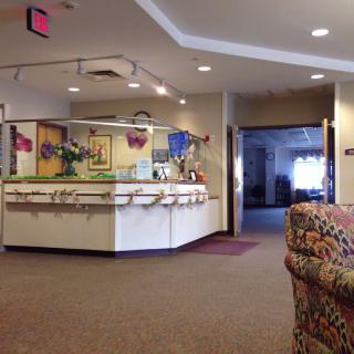 A view of a reception area in a lobby with seating and decor.