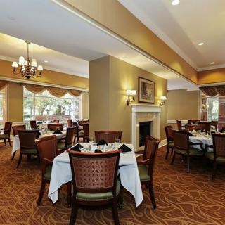 An elegant dining area with neatly arranged tables and a warm ambiance.