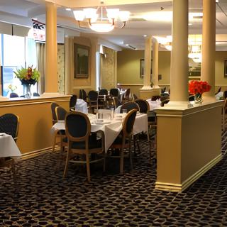 An elegant restaurant interior with neatly arranged tables and chairs.