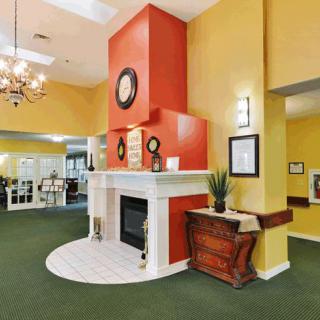A brightly colored lobby with a central fireplace and decorative elements.
