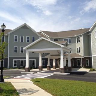 A modern residential building with a welcoming entrance and well-maintained surroundings.
