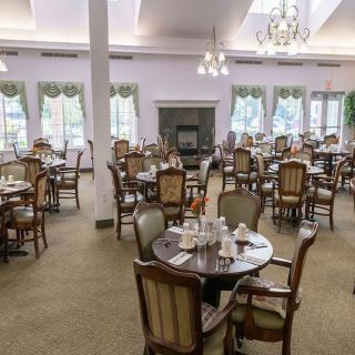 A spacious dining room with elegantly set tables and classic decor.