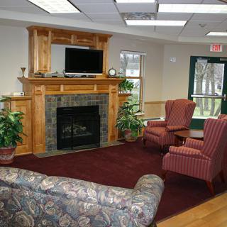 Cozy living room with a fireplace, television, and comfortable seating.