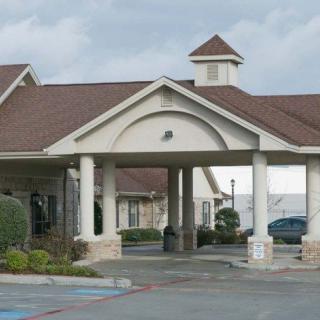 The exterior entrance of a hotel with a covered driveway.