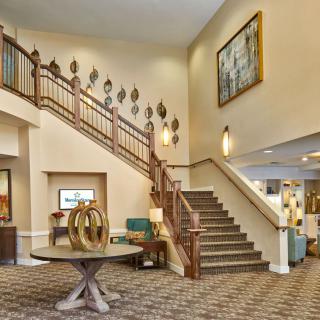 A modern hotel lobby with a staircase and stylish decor.