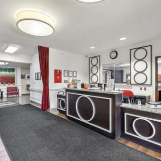 A modern reception area with a black and white themed interior, featuring contemporary furnishings and stylish lighting.