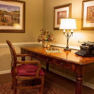 A cozy office setting with a wooden desk, vintage typewriter, and warm lighting.